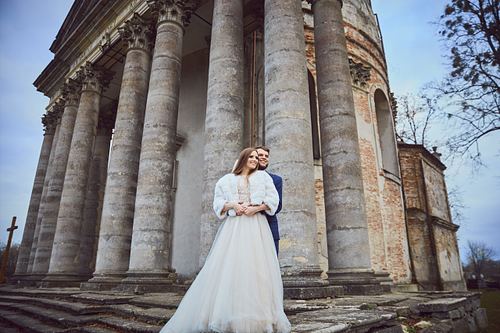 Romantic bride and groom portrait near Pidhirtsi Castle