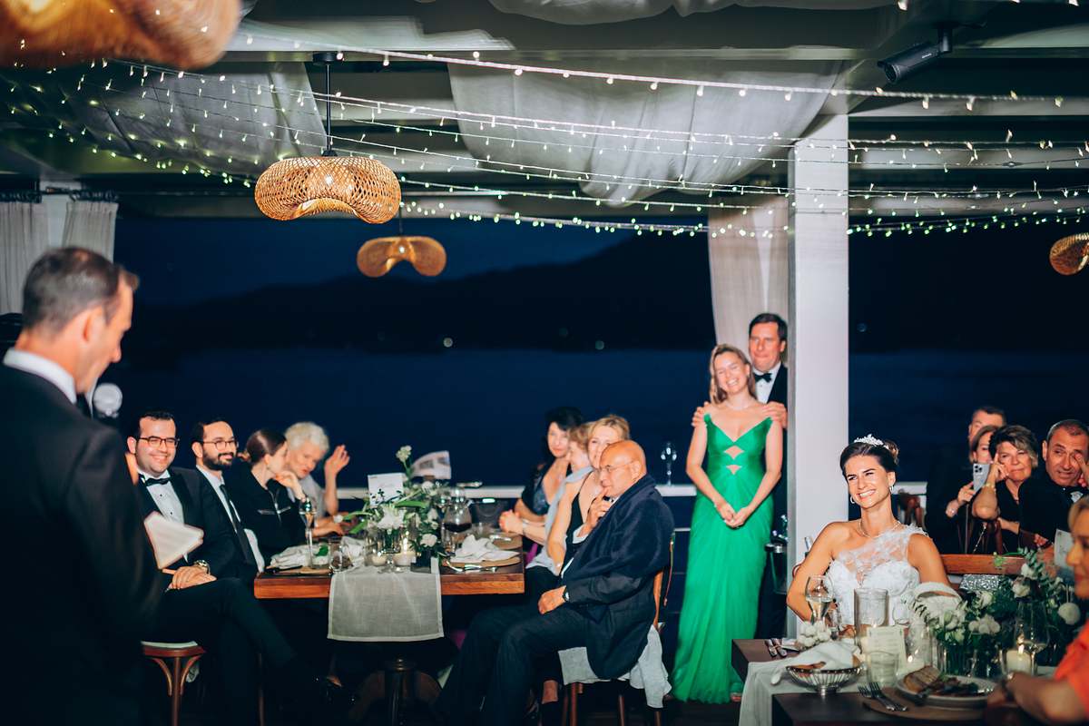 Guests listening to the groom's speech during the Göcek wedding reception
