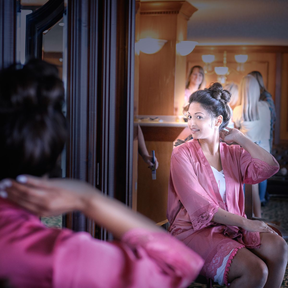 glowing bride looking in the mirror after hair and make-up is completed at Golden Sand's bridal suite in Ocean City, MD