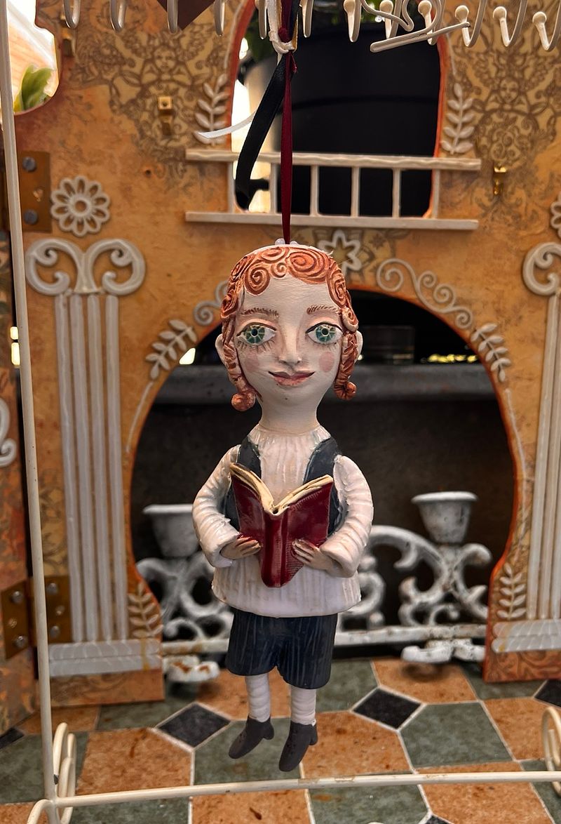 Traditional boy with a book, little ceramic hanging sculpture