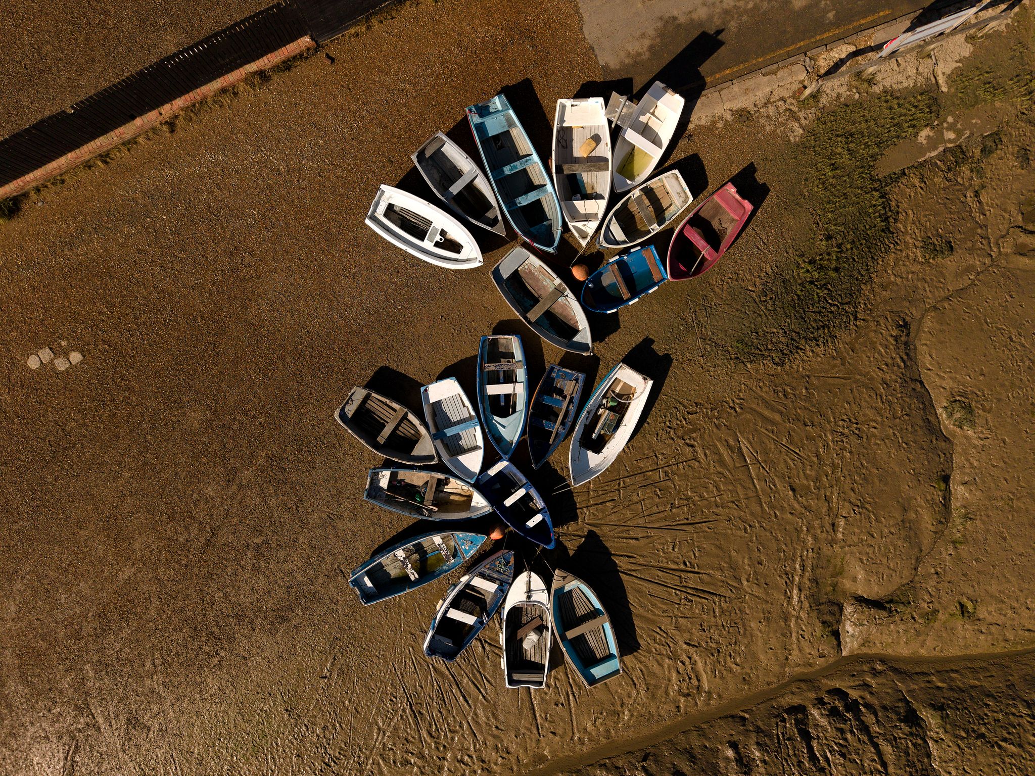 Aerial photograph of boats resying on mudflats at low tide at Tollesbury Marina, Essex