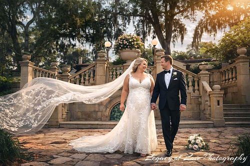 Bride and groom with a flowing veil at Epping Forest Yacht & Country Club in Jacksonville