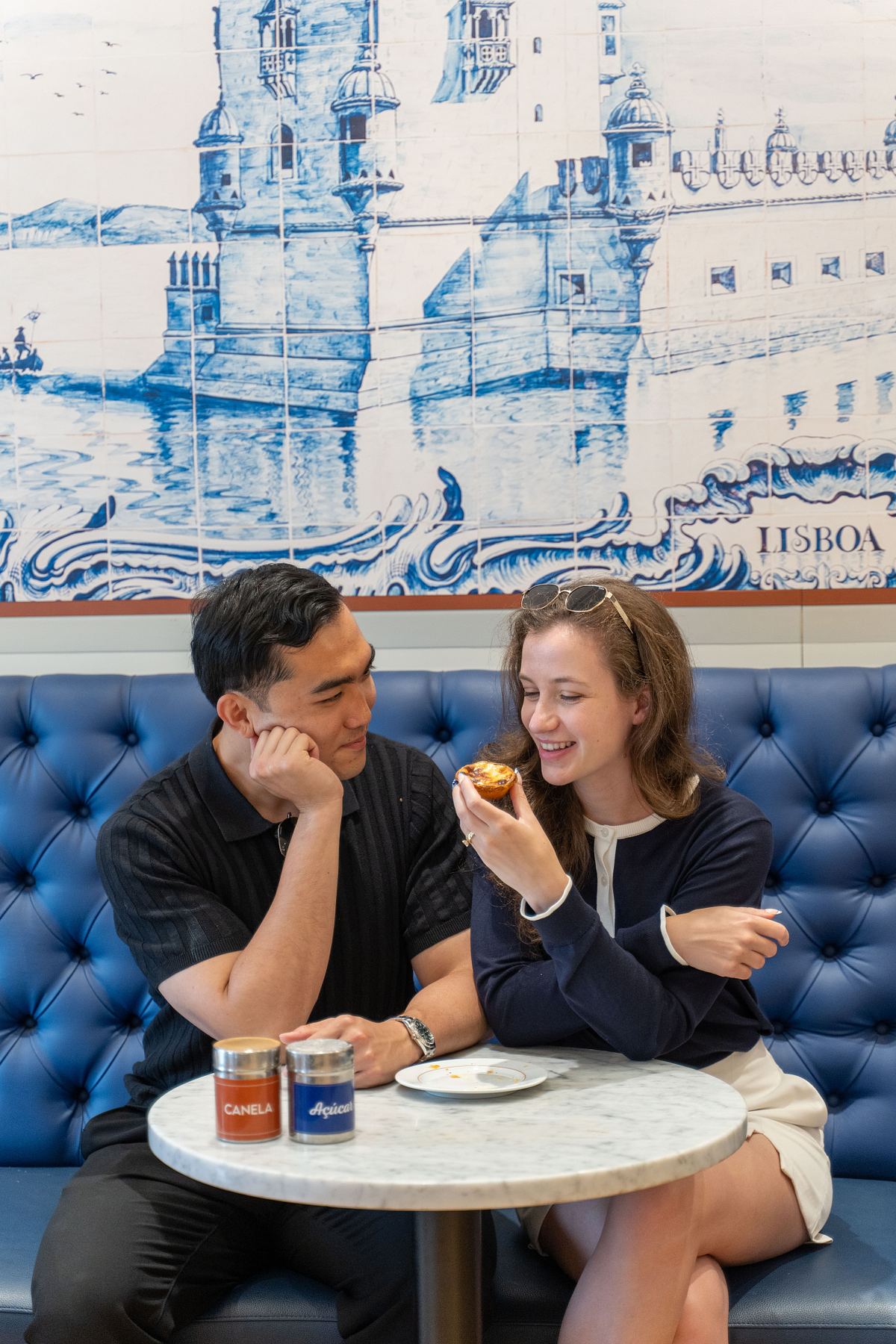 Couple enjoying coffee in a Lisbon caf&eacute; with blue tiles