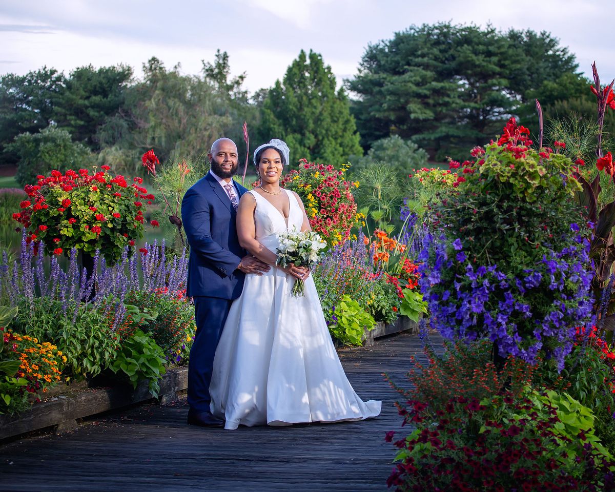 bride and groom posing at baywood on the bridge on the golfcourse