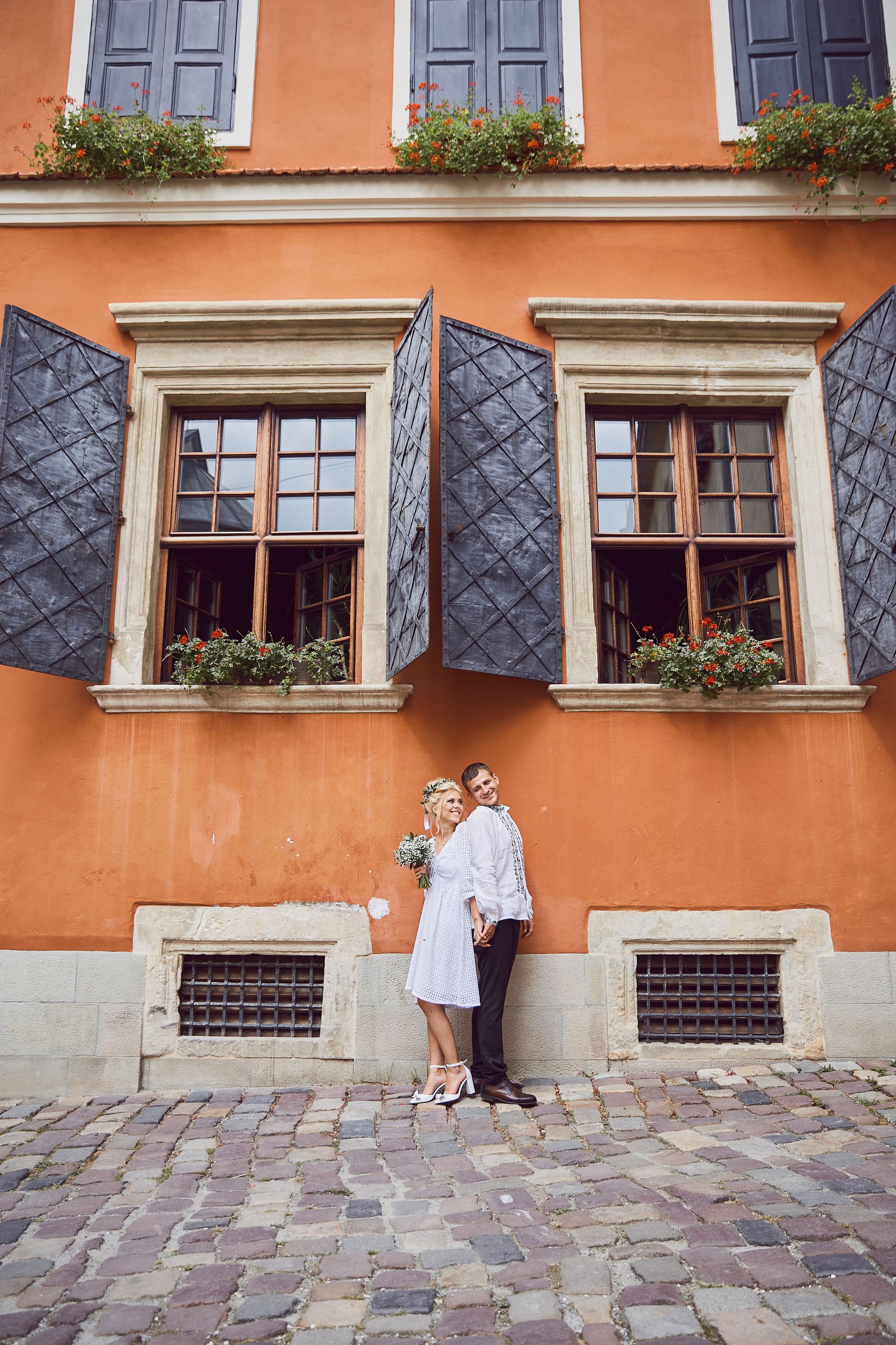 Bride and groom portrait against historic architecture in Lviv