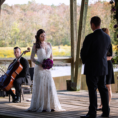 autumn wedding on the chesapeake bay with the tree leaves glowing and the sun slowly setting