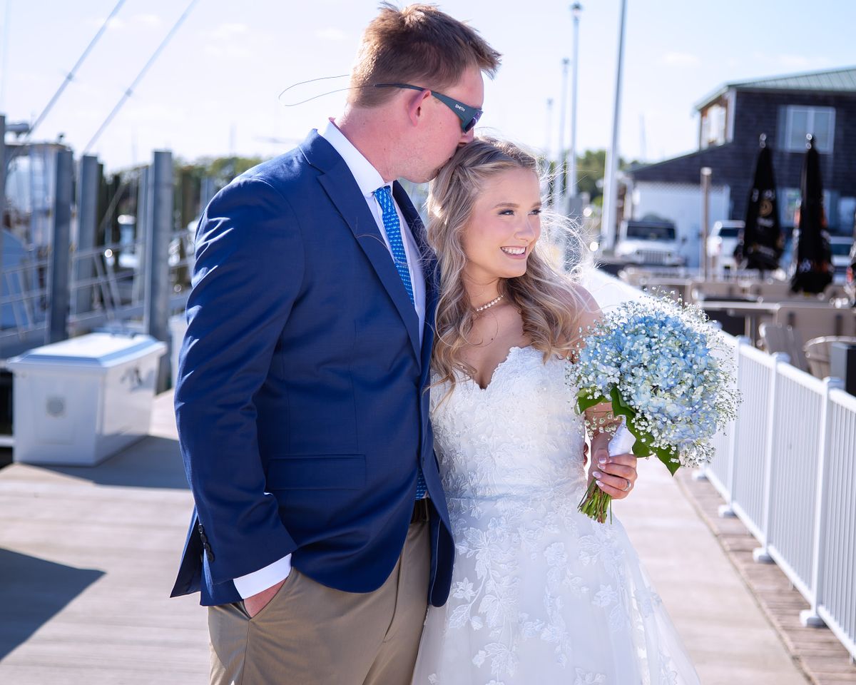 candid moment between bride and groom on the pier at Irish Penny, Lewes, de
