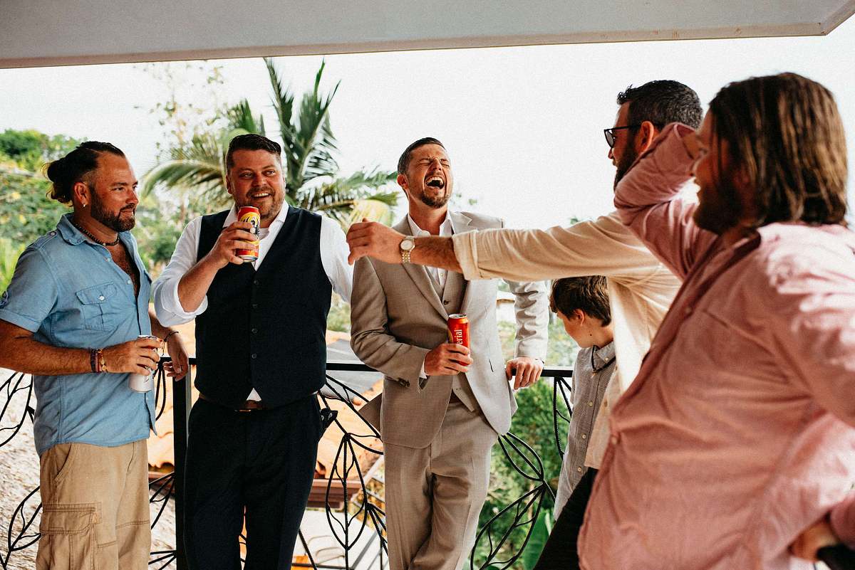 Groom laughing with groomsmen in Manuel Antonio