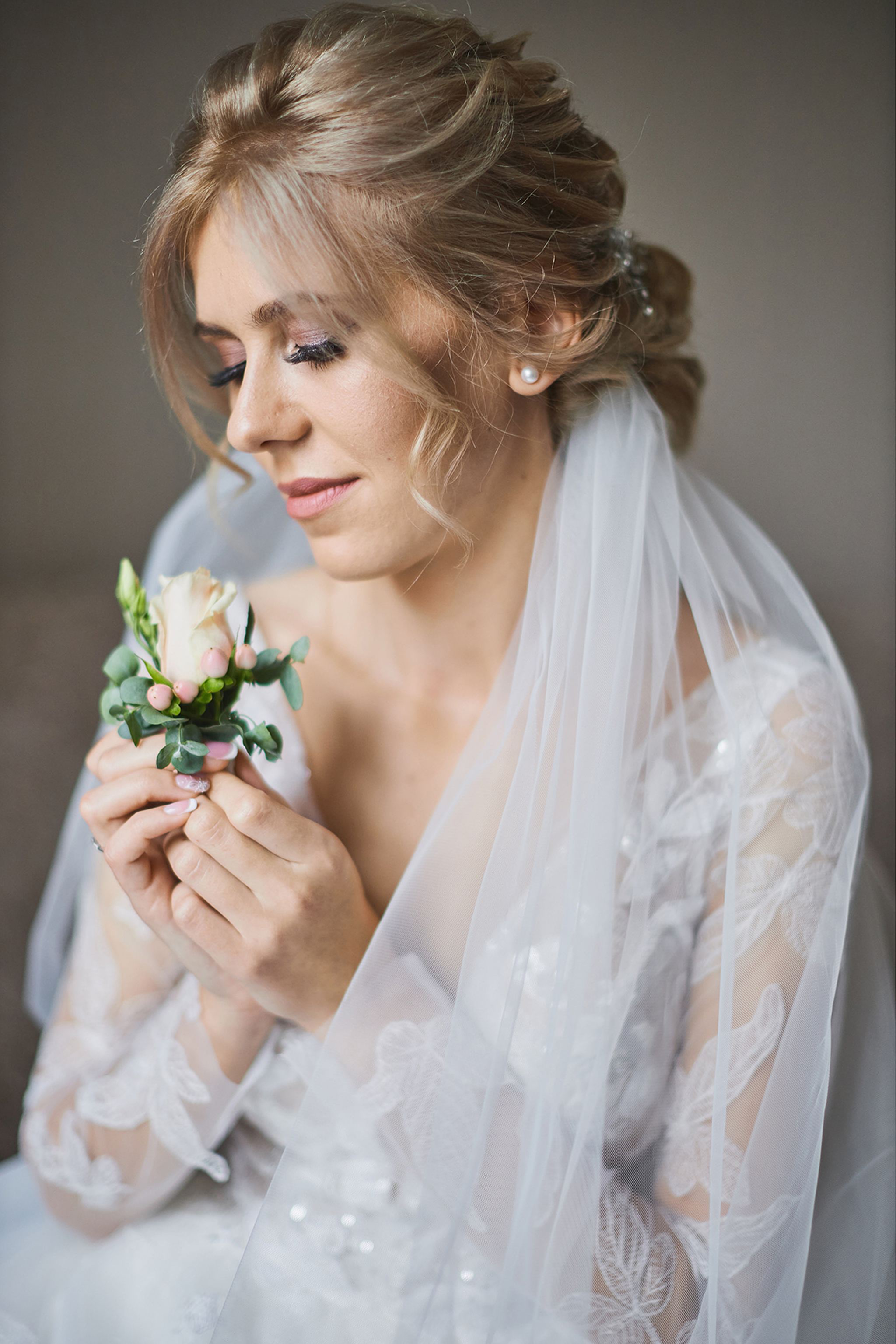 Soft bridal portrait with veil and delicate floral detail