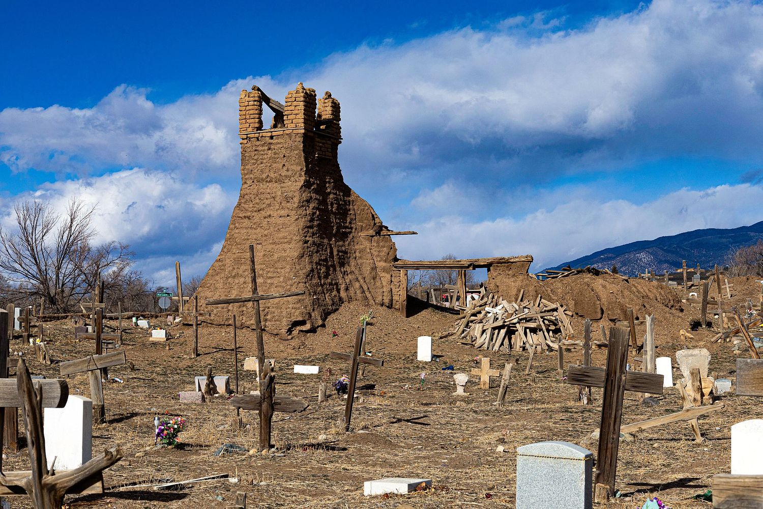 Picture of crosses in front of an abandoned tower at Taos Pueblo, NM.