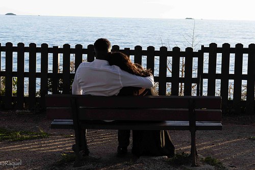 Couple enlacé sur un banc face à la mer lors d’une séance photo à Carqueiranne.