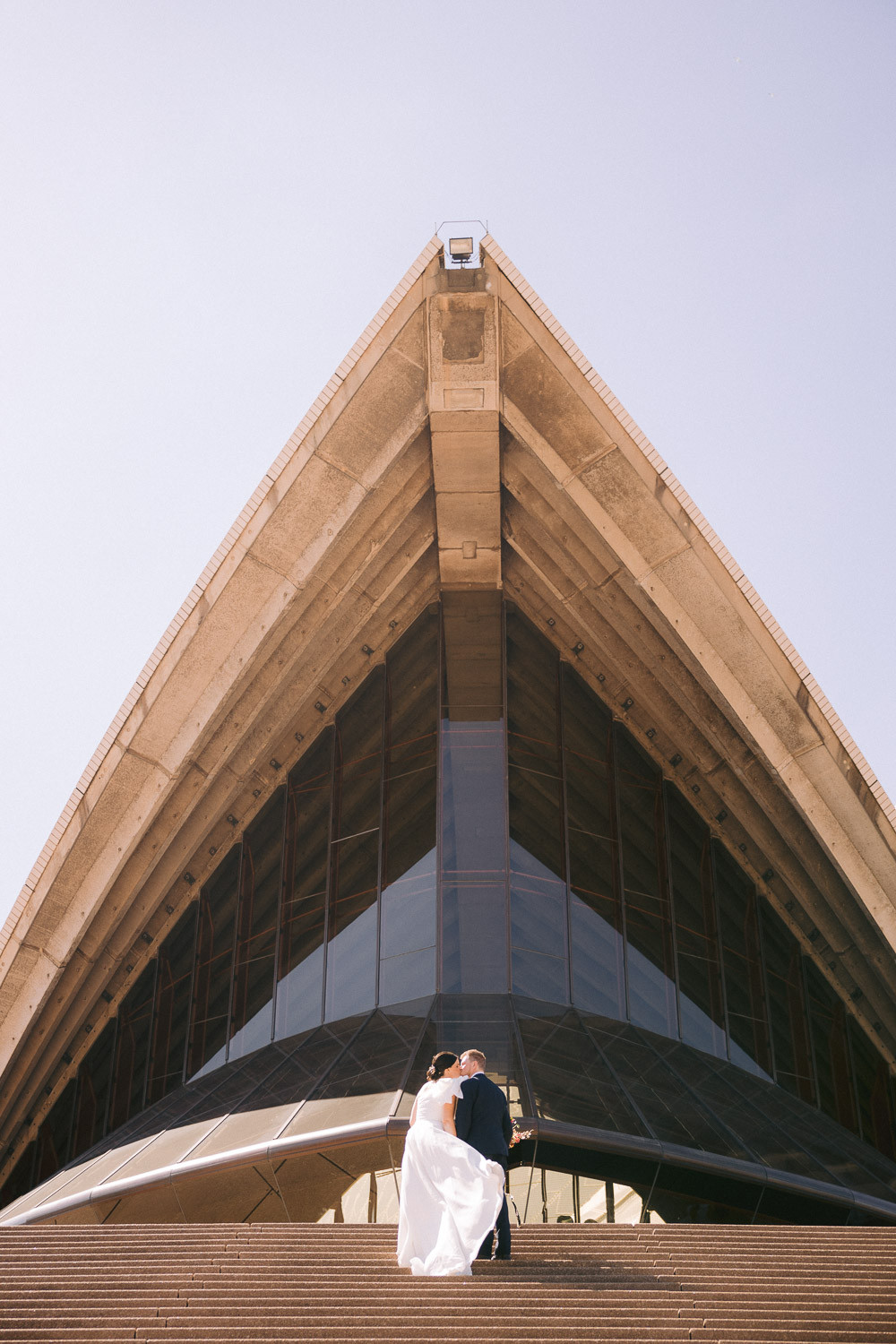 bride and groom at the Sydney Opera House for their bridal portraits session after their elopement.