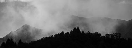 Panoramic mountain ridges fading into atmospheric mist – fine art landscape photography
