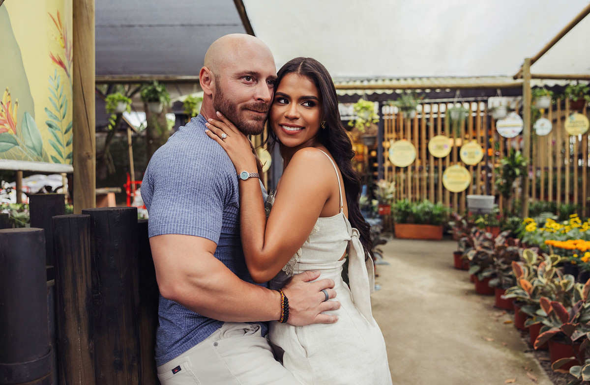 Couple embracing in a plant filled outdoor patio in Envigado