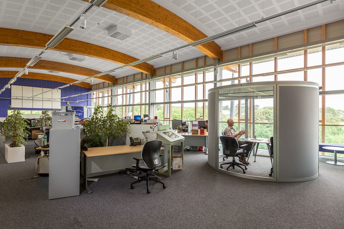Interior of AIR building Cornwall, showing open-plan office with large windows and natural light.