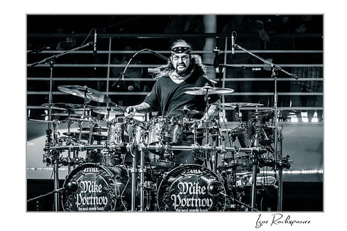Mike Portnoy Live Concert Print  Horizontal black and white image of Mike Portnoy performing behind a large double bass drum kit during a live concert