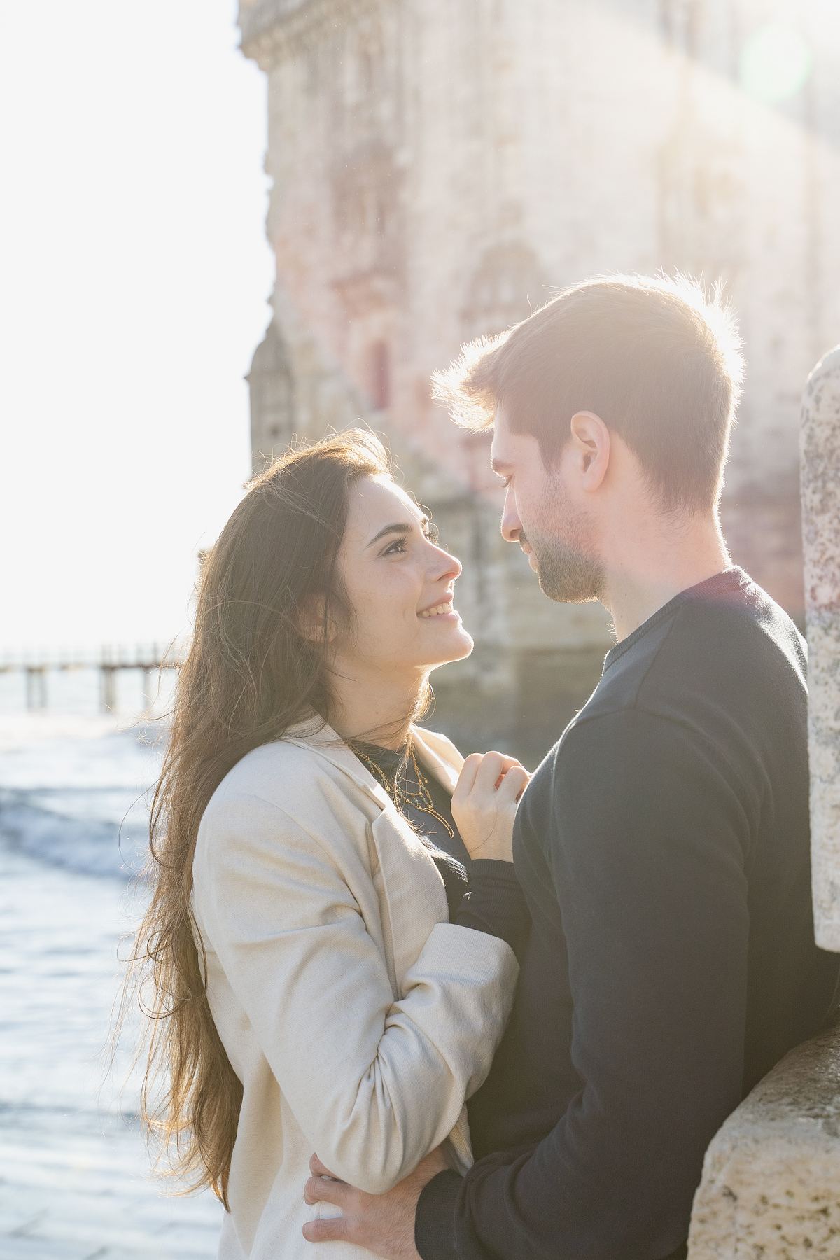 Couple embracing beside a historic Lisbon building