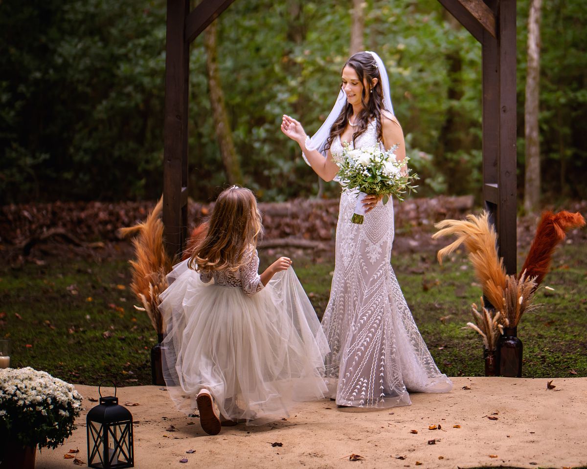 candid moment between the flowergirl and the bride after the ceremony at a eastern shore wedding