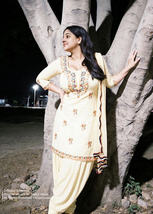 Nighttime fashion portrait featuring Nupur Ahuja in a graceful walking pose