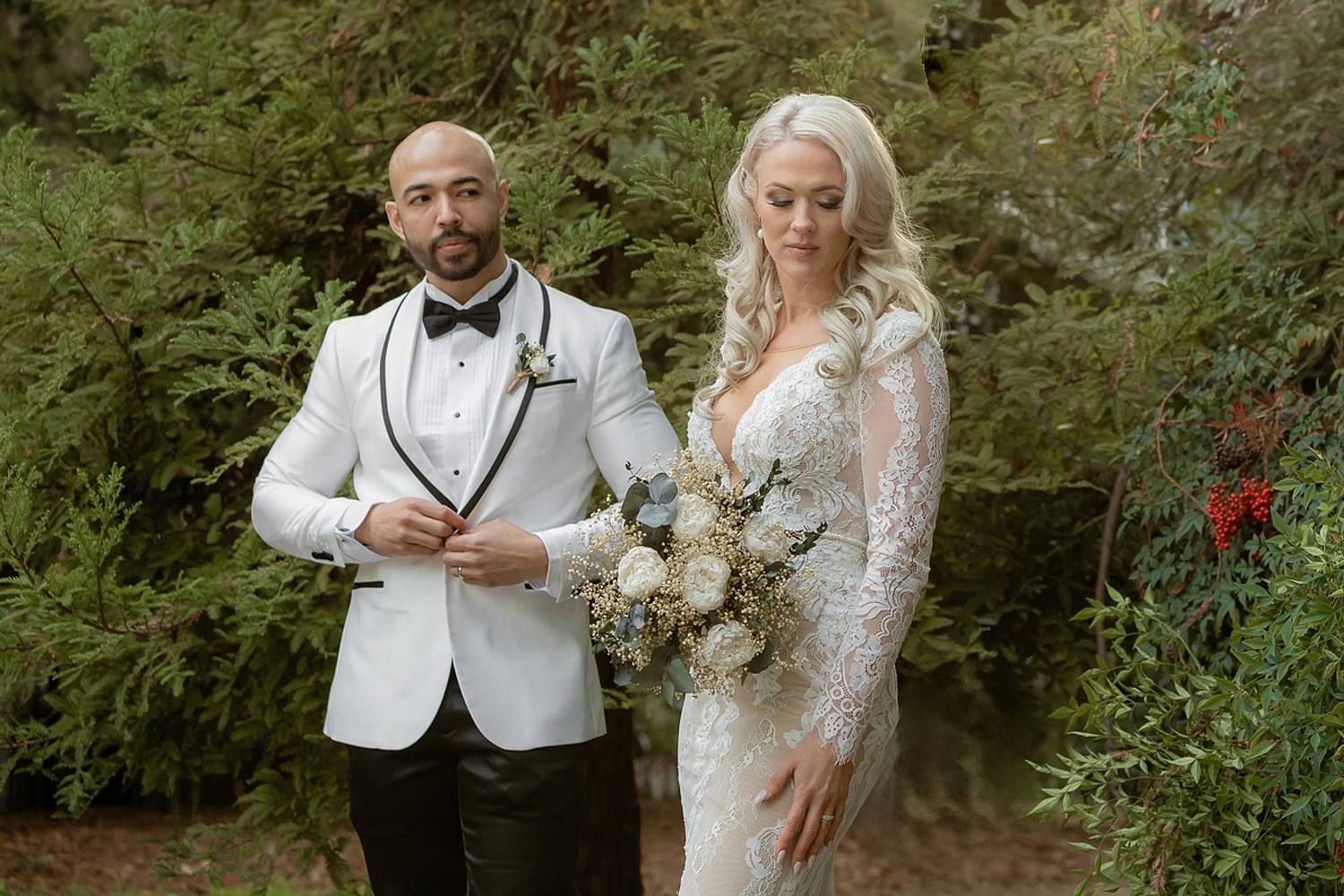 Bride & groom in all white in woods
