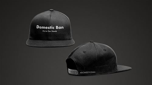 Mockup of the front and back of a black campaign baseball cap, with the front featuring the campaign name and tagline, and the back featuring the campaign hashtag beside the snapback closure.