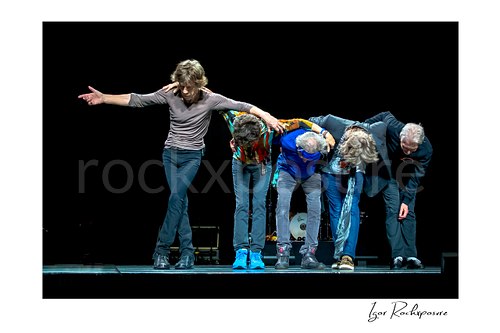 Horizontal color image of Mick Jagger, Mick Taylor, Keith Richards, Ronnie Wood and Charlie Watts of The Rolling Stones taking a bow on stage