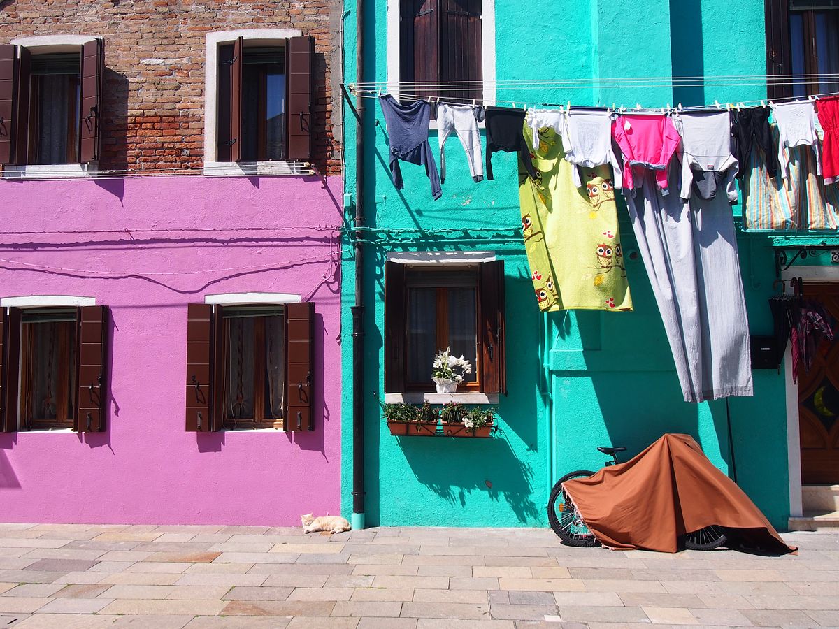 Colourful houses, hanging laundry and a bicycle on the island of Burano, Italy.