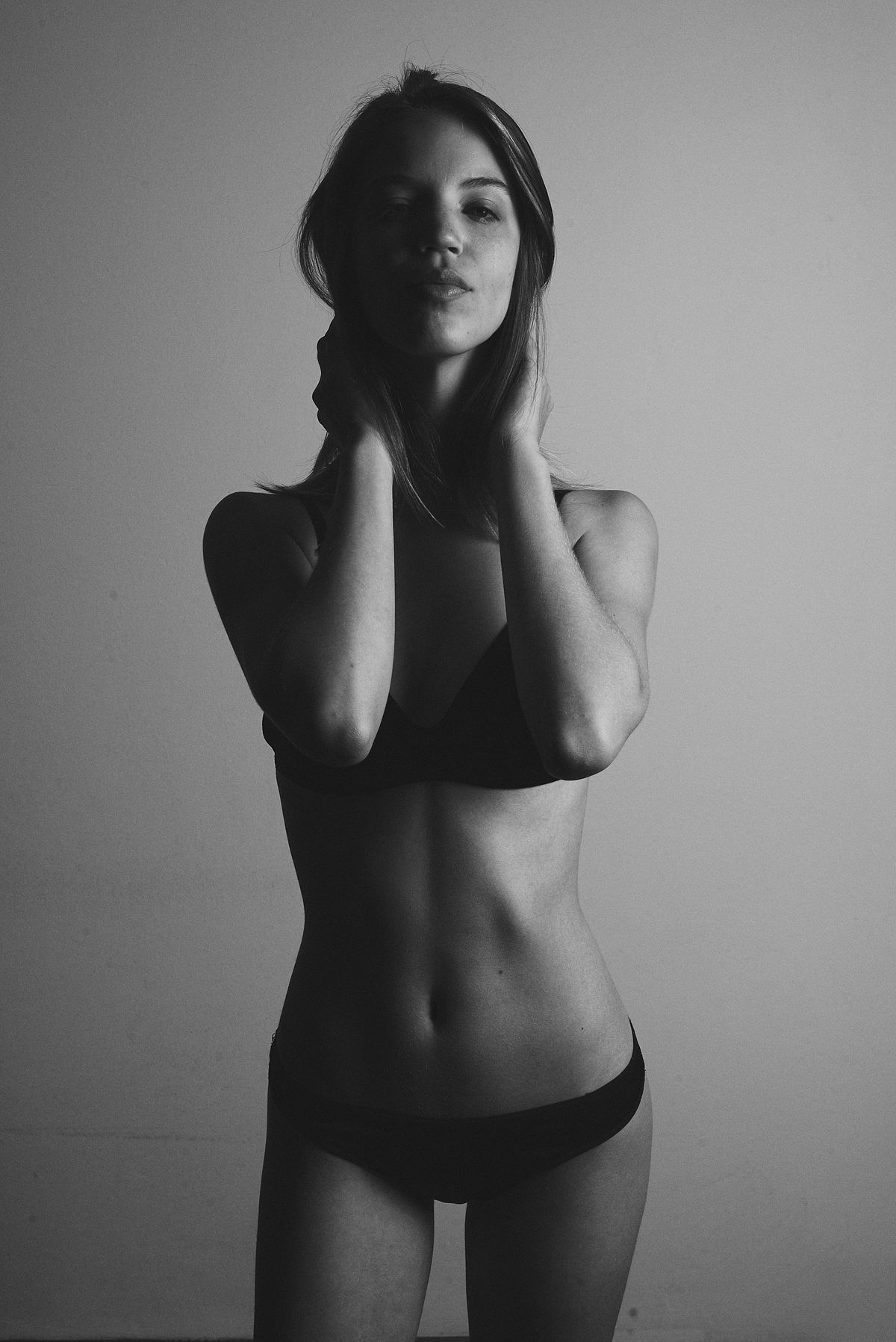 Black and white polaroid style portrait of a woman in bikini with half body in shade, Clever Management Buenos Aires, by Gabriel Matula.