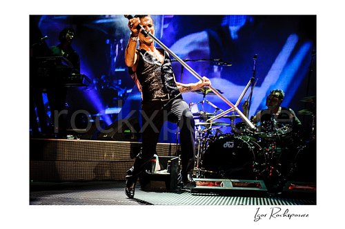 Horizontal color image of Depeche Mode members Dave Gahan and Christian Eigner performing on stage