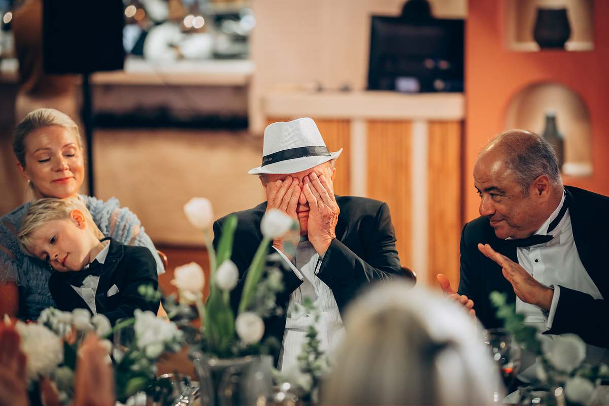 Emotional guest reacting during wedding speeches at the reception