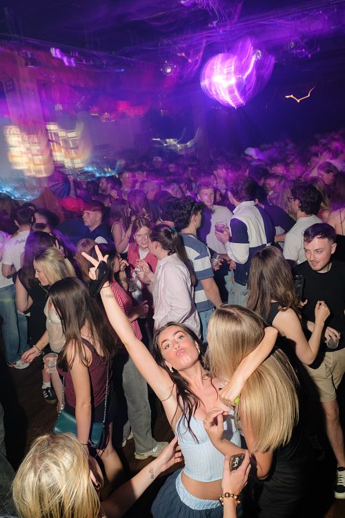 event photography at a nightclub in Vancouver with face painting happening in the foreground