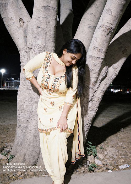 Streetlight illuminated portrait featuring Nupur Ahuja in a yellow embroidered suit.