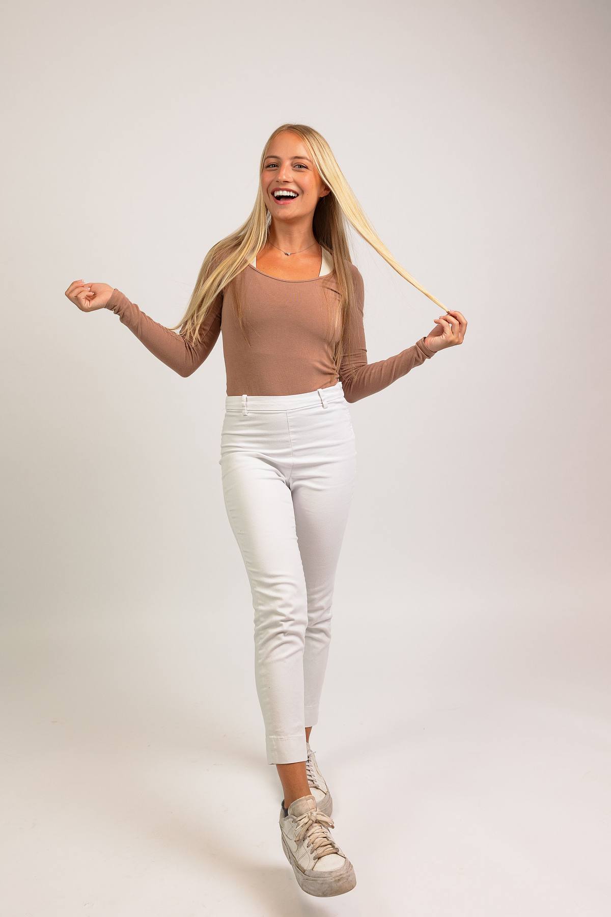 A full-body photograph of a woman against a white backdrop at Innovate Carolina's offices in Chapel Hill, NC