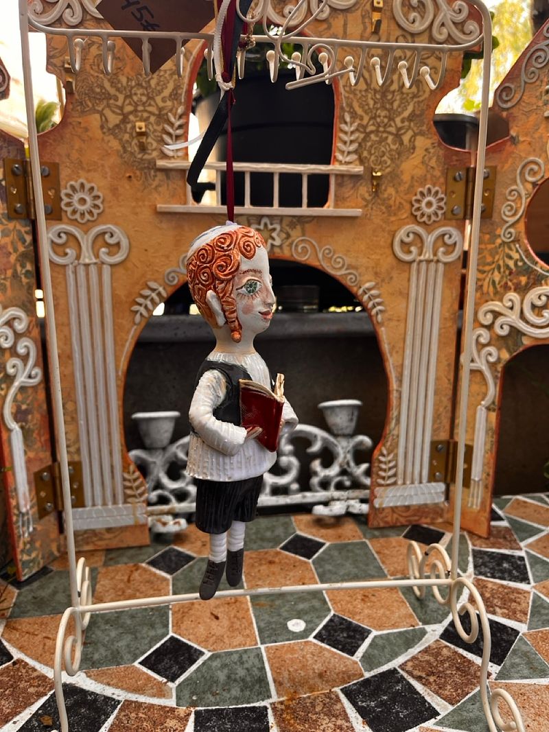 Traditional boy with a book, little ceramic hanging sculpture