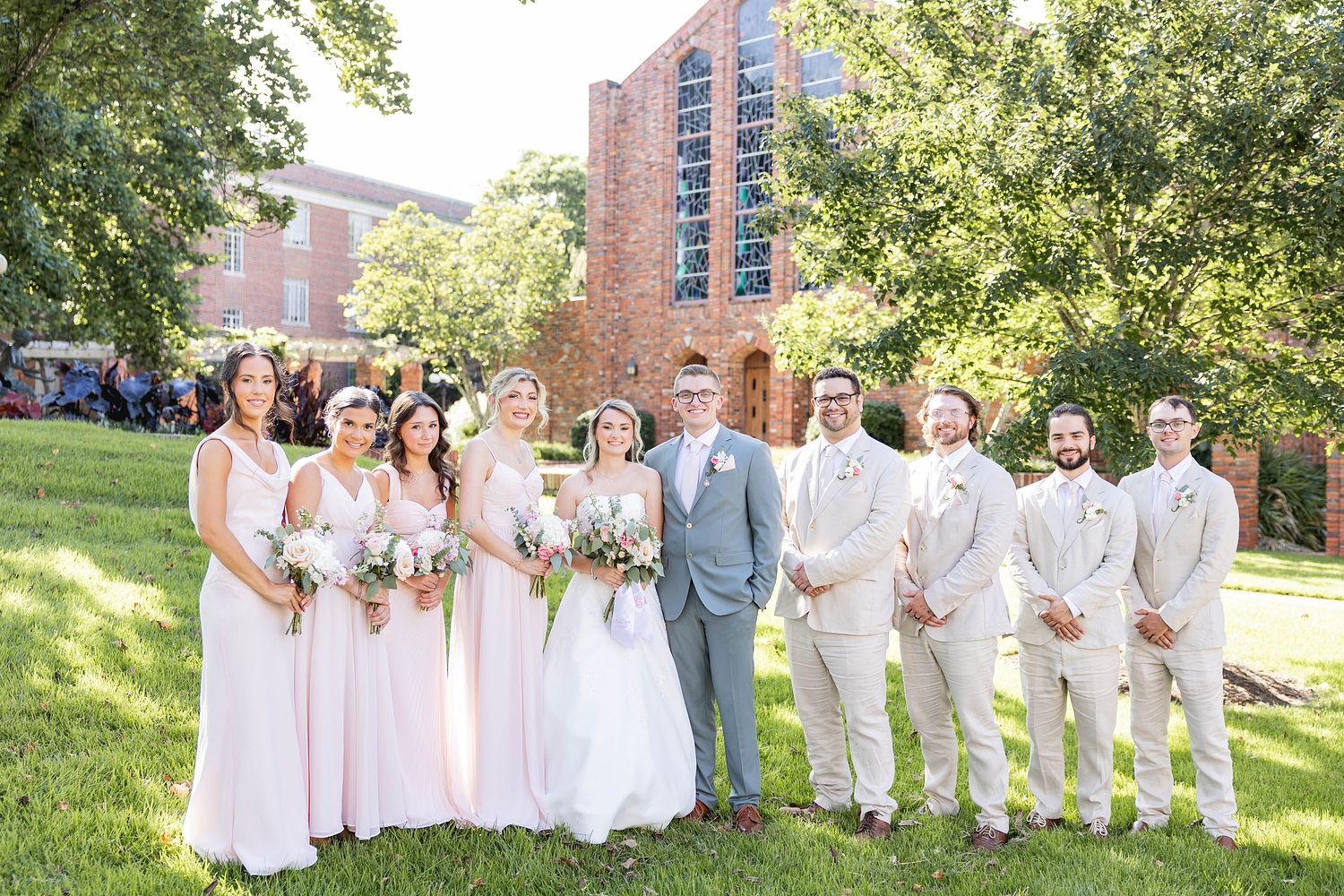 Bride and Groom with Bridesmaids and Groomsmen pose in front of the Chapel of Memories for a wedding on Mississippi State University's campus in Starkville, MS.
