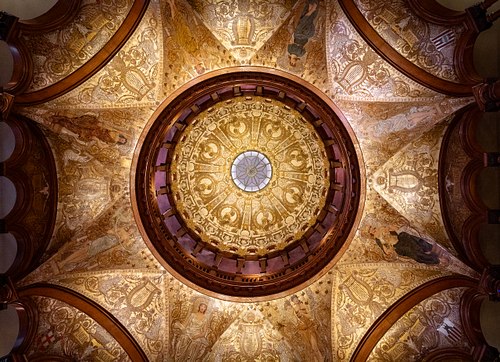 Ground-up view of the ornate ceiling mural surrounding the rotunda oculus at Flagler College, St. Augustine.