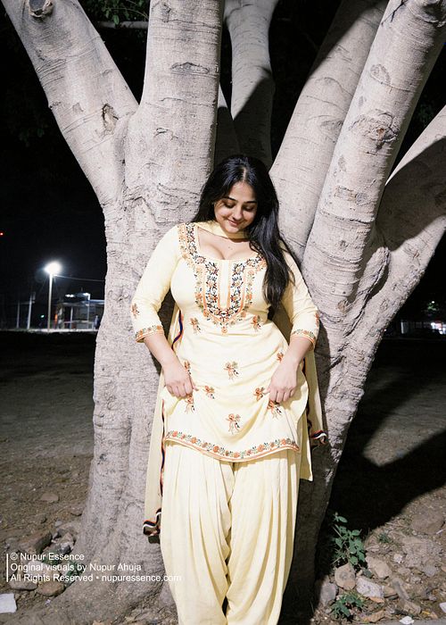 Night photography portrait featuring Nupur Ahuja in a yellow Punjabi outfit