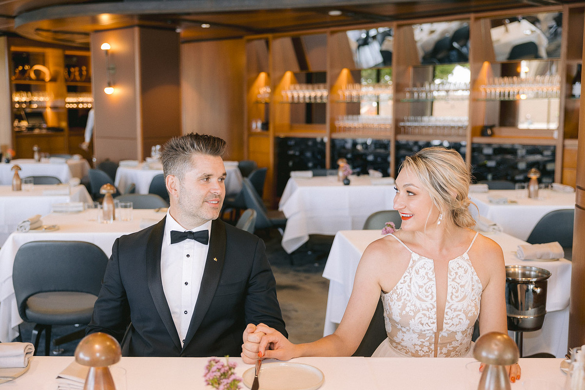 bride and groom celebrates at Aria restaurant next to the harbour after their elopement