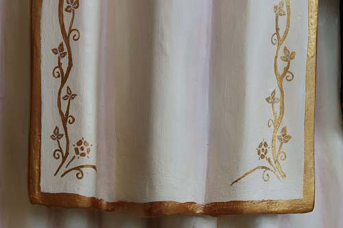 Gold floral trim on the white scapular on the restored St Rose statue