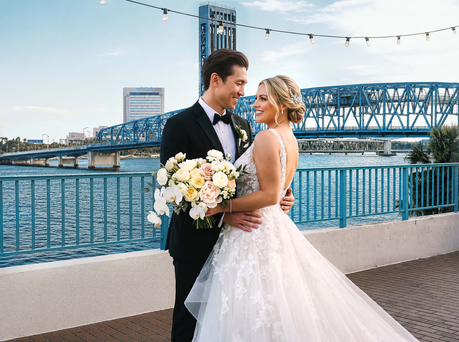 Jacksonville wedding photographer capturing a bride and groom with the Main Street Bridge and downtown skyline in the background.