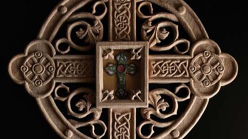 Close up picture of the carving on the reliquary and the relic itself.