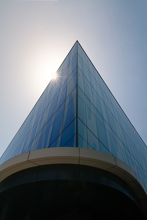 Angular blue glass corner of One Performance Plaza in Lake Nona, Orlando, by HuntonBrady Architects