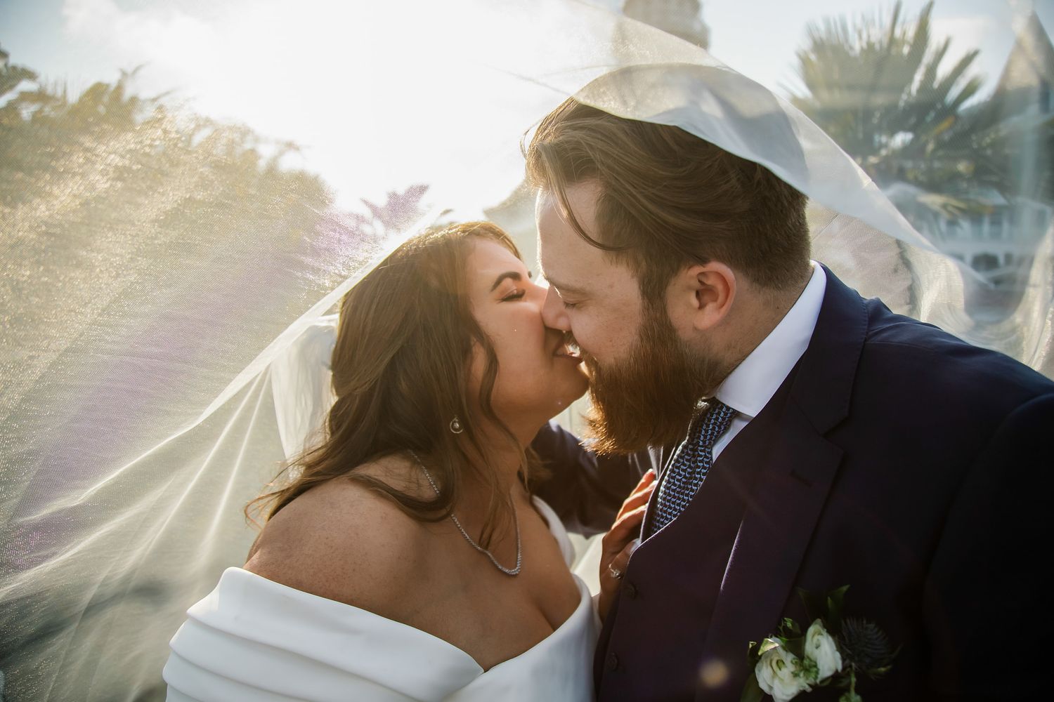 Bride and groom kissing under the wedding veil at Hotel del Coronado in San Diego