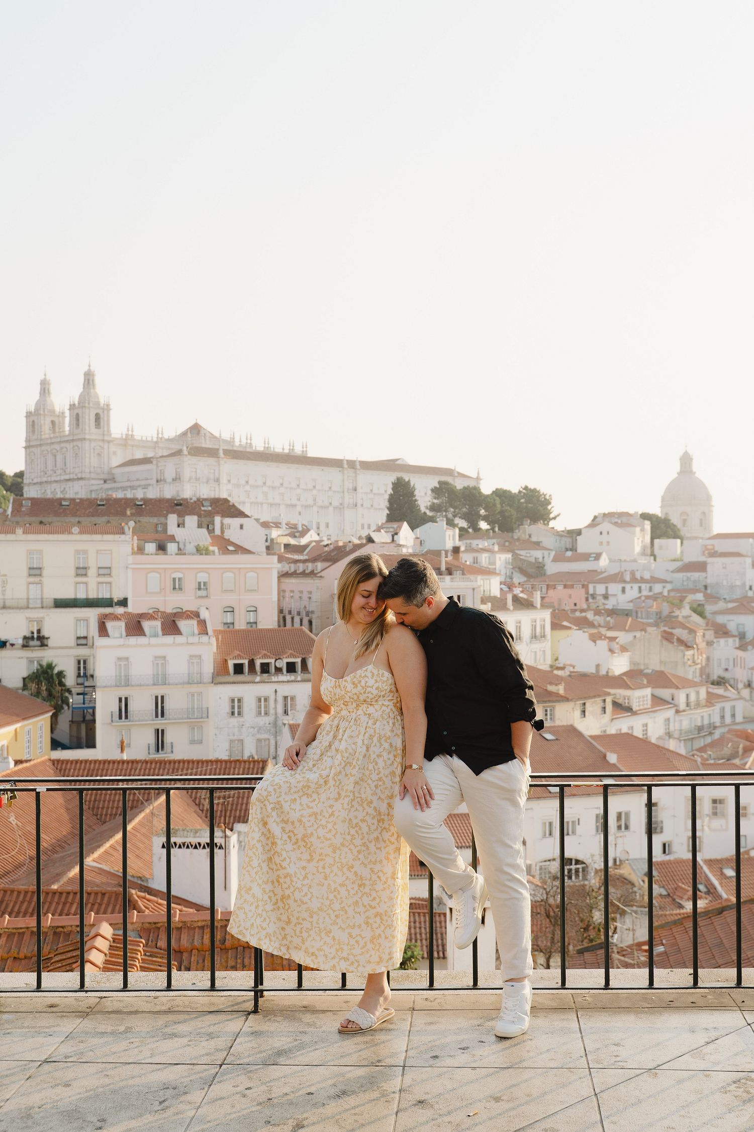 Couple enjoying a romantic photoshoot at a Lisbon viewpoint
