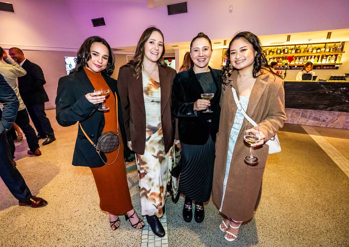 Four friends pose for a photo with drinks, at the Adnews Emerging leads awards.
