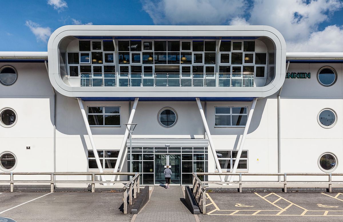A woman walks into the enrance of Penwith College modern campus building, Penzance Cornwall.