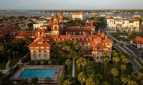 Side aerial view of Ponce de Leon Hall at sunset, along King Street near the Matanzas River in St. Augustine.