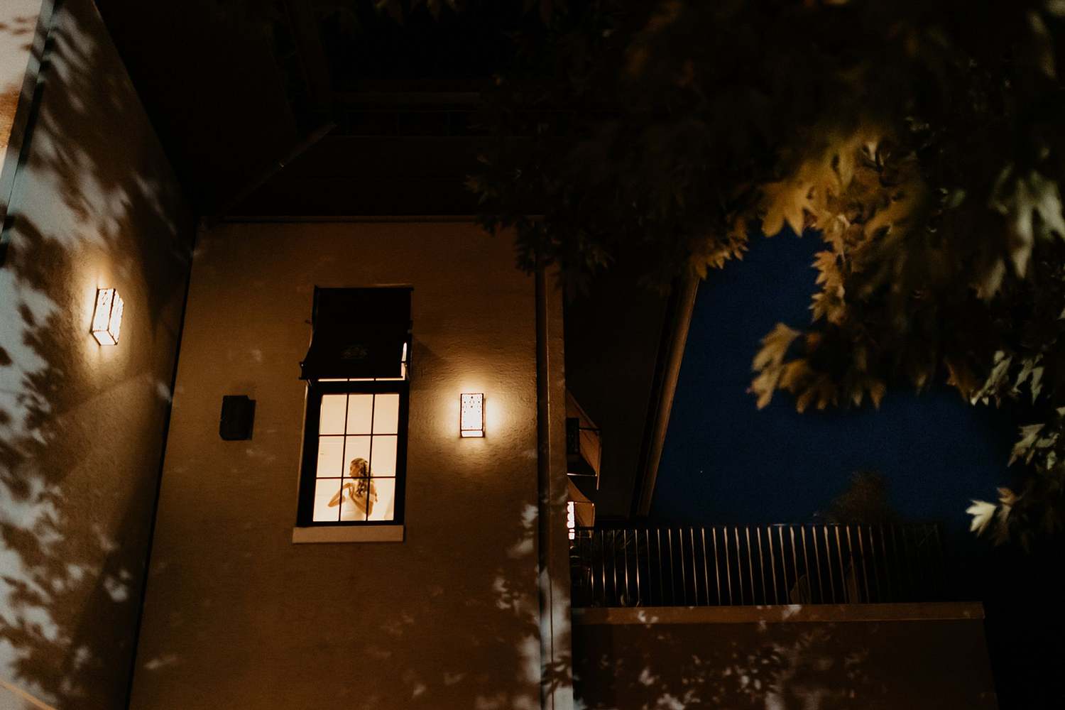 Bodrum wedding photographer – night-time bridal prep, hotel window silhouette