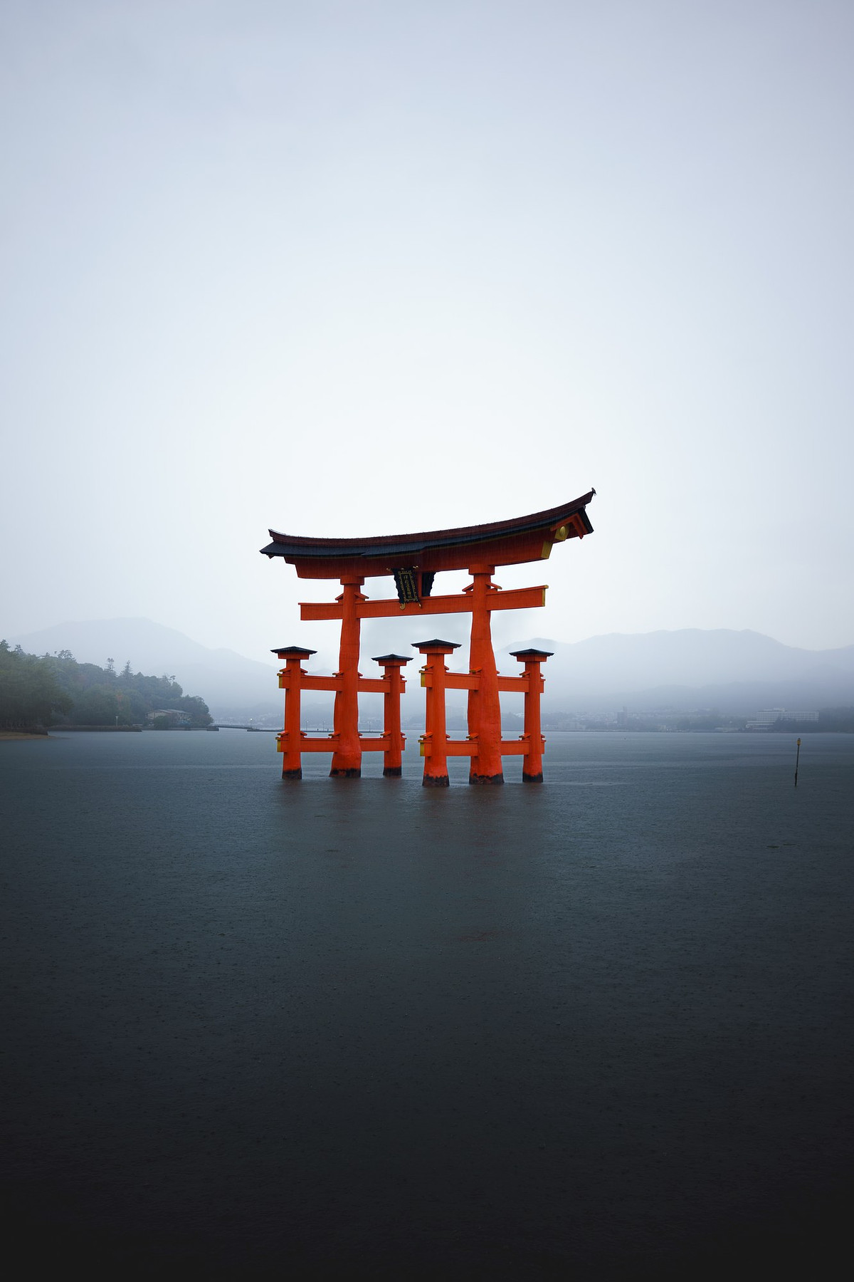 Le torii flottant d'Itsukushima à marée haute sous la pluie et la brume, Miyajima