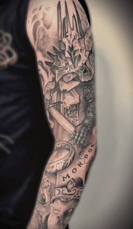 Realism Lord of the Rings sleeve tattoo featuring Sauron, the One Ring, and King of the Dead, highly detailed black and grey shading, created in Stoke-on-Trent by Alika Tattoo Art.